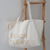 Bolso de playa de lona, color beige, por favor.