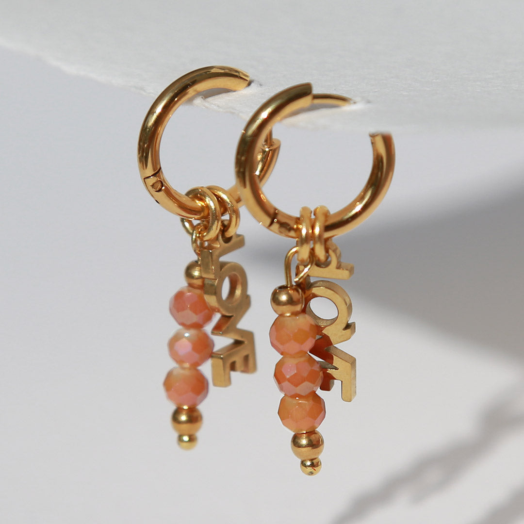Gold faceted 'Love' earrings – orange